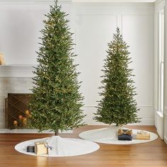 two christmas trees in the middle of a living room