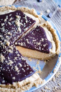 there is a chocolate pie on the plate with one slice cut out and ready to be eaten