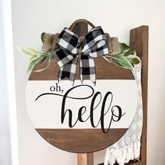 a wooden sign that says oh hello with a bow hanging on the front of it