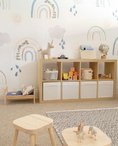 a child's playroom with toys, bookshelves and other items on the floor