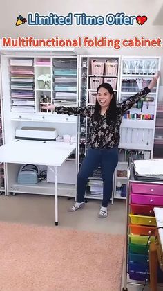 a woman is standing in front of a desk and she has her arms up to the ceiling