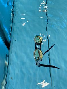 two goggles floating in the water next to each other