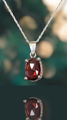 Indulge in the timeless beauty of this Rose-Cut Garnet Necklace, featuring a richly hued gemstone known for its deep red allure. Set in fine sterling silver, this January birthstone pendant exudes elegance with its classic cut and sophisticated charm. Perfect for both casual and formal occasions, this piece adds a touch of refined grace to any ensemble. ✳︎Material: High Quality Solid 925 Sterling Silver & Natural Garnet  ✳︎Width: 9mm ✳︎High:21mm  ✳︎Gemstone Color: Red  ✳︎Gemstone Size: 12×8mm ✳︎Chain: Solid 925 Sterling Silver ♡Shipping & Packaging♡ Items in stock will be shipped within 2 business days.  For custom orders, please allow one to two weeks for production before shipping.  All pieces will be shipped in a beautifully wrapped box. Certainly, they are also perfect for gifting. ♡Ou Red Gemstone Birthstone Necklace Gift, Red Garnet Oval Pendant Necklace, Red Gemstone Birthstone Necklace In Sterling Silver, Garnet Oval Pendant Necklace As A Gift, Ruby Oval Pendant Necklace For Gift, Red Sterling Silver Necklaces For Birthday, Garnet Pendant, Garnet Necklace, Shipping Packaging