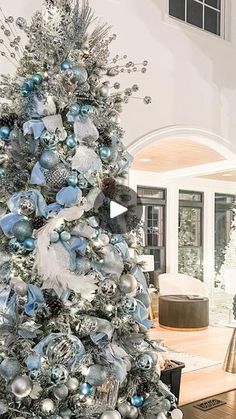 a silver and blue christmas tree in a living room