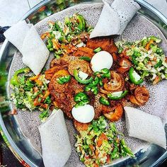 a silver plate topped with lots of different types of food