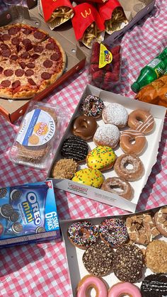 there are many different types of doughnuts on the table and one has a slice of pizza