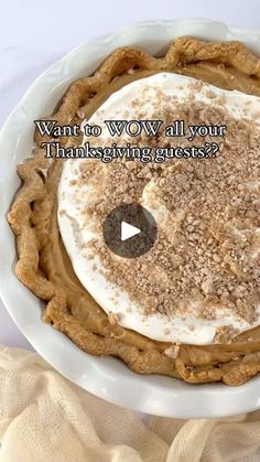 a white plate topped with a pie covered in whipped cream and cinnamon crumbs