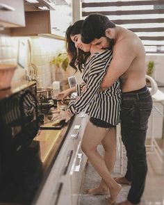 a man and woman standing in front of an oven