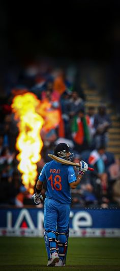 a man holding a baseball bat on top of a field in front of a crowd