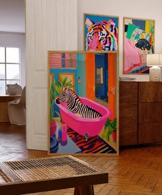 a zebra in a pink bathtub with paintings on the wall behind it and wooden flooring