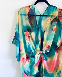 Details Kimono inspired silhouette. All over print. Cut in a loose fit. Semi-sheer and lightweight. Perfect for all occasions. Everyday with jeans and a tank. To a wedding or event over a simple dress. Over PJ's with your bridesmaids while you prepare for your big day. Over a bathing suit at the beach because this is the perfect material as it won't retain sand and will dry ultra fast. Even an outdoor concert or festival with a floral crown and some short shorts :) Content & Care * Silky Polyest Multicolor Printed Wrap Cover-up, Multicolor Printed Cover-up With Kimono Sleeves, Green Digital Print Top For Summer, Summer Kimono With Abstract Print And Kimono Sleeves, Summer Kimono With Abstract Print, Tropical Printed Festival Cover-up, Flowy Multicolor Printed Kimono, Blue Abstract Print Top For The Beach, Multicolor Printed Beachwear Tops