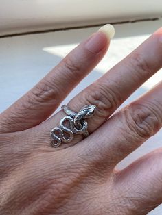 Snake Sterling Silver ring, Coiled Serpent Silver ring, size 6.5 Sterling silver serpent snake ring.  Snake is a Symbol of eternal love.  Great for women and men.  An excellent gift idea for special someone who like tribal or gothic  Ring size:  6.5 Rear ring band:  mm Hallmark:  "925" inside ring band Estimated Era:  early 1990's  Condition:  very good. (unused item from old inventory items.) Photos are the actual item's pictures, please see all photos for actual item's condition.  (Please do note that vintage items sometimes might have that special age natural patina look due to they are old. If you look for the perfect brand new item, this item might not be your perfect choice.)  Shipping charge is for the First Class Postage within U. S., the protective bubble envelope and gift box or Snake-shaped Metal Rings As A Gift, Snake Shape Metal Ring As Gift, Adjustable Spiral Snake Ring As Gift, Adjustable Symbolic Snake Ring, Silver Symbolic Snake Shaped Ring, Silver Snake Ring For Promise, Spiritual Snake Ring As Gift, Spiritual Snake Ring For Gift, Silver Symbolic Snake Promise Ring