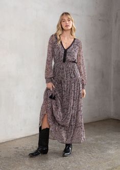 Full of dreamy bohemian details, this elevated maxi dress is designed in an autumnal paisley print. With a flattering empire waist, delicate crochet trim, and voluminous long sleeves. The tiered skirt adds shape and movement to this ethereal style. Paisley print Relaxed fit Long voluminous sleeves Smocked elastic cuff Maxi length Tiered skirt V-neckline Elastic waist with tassel ties Open back with self-covered button closure Contrast crochet trim Sheer Attached lining Bohemian maxi dress Model Ethereal Style, Delicate Crochet, Paisley Maxi Dress, Voluminous Sleeves, Bohemian Maxi, Bohemian Maxi Dress, Black Orchid, Crochet Trim, Tier Skirt