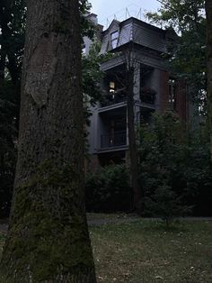 an old house is surrounded by trees and grass