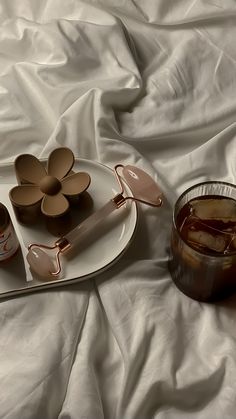 an assortment of desserts on a white plate next to a jar of jam and spoon