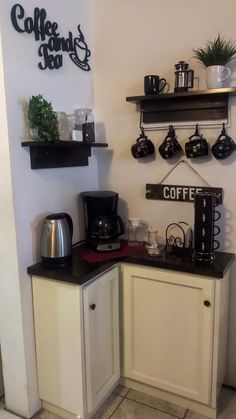 there is a coffee maker on the counter in this kitchen