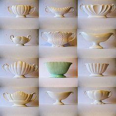 many white cups are lined up on the wall and placed in front of each other