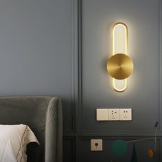 a bed room with a neatly made bed and a light on the wall above it