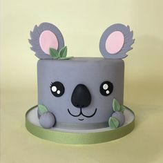 a cake decorated to look like a koala bear with leaves on it's ears