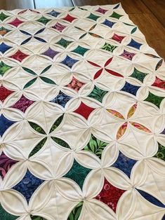 a quilted table topper on a wooden floor