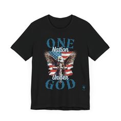 Wear your faith and patriotism boldly with our "One Nation Under God" patriotic T-shirt. It features a striking design of an American Bald Eagle, a Cross, and the iconic American flag. Crafted from Bella Canvas 3001 T-shirt blanks, this premium garment offers unmatched comfort and style. The symbolic design embodies the unity of faith and national pride, with the Bald Eagle symbolizing strength and freedom standing behind the Cross, a testament to our nation's foundation on Christian principles. Patriotic Black T-shirt For Veterans Day, Patriotic Made In Usa T-shirt For Memorial Day, Patriotic T-shirt For Memorial Day, Made In Usa, Patriotic T-shirt Made In Usa For Memorial Day, Black T-shirt With American Flag For 4th Of July, Patriotic 4th Of July Streetwear T-shirt, Patriotic Flag Print T-shirt For Labor Day, Black Graphic Print T-shirt For 4th Of July, Americana T-shirt With American Flag For Memorial Day