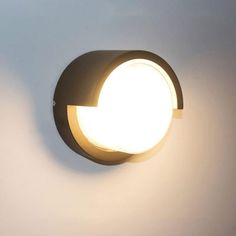 a light that is on the side of a wall in a room with white walls