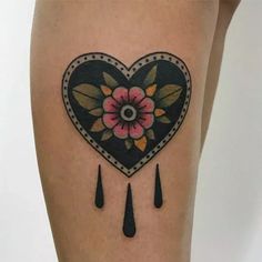 a heart shaped tattoo with flowers and rain drops