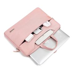 an open pink laptop bag sitting on top of a white laptop computer next to it's contents