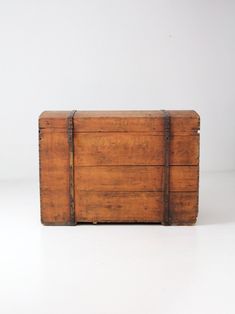 an old wooden box sitting on top of a white floor