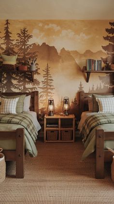 two beds in a room with mountains and trees painted on the wall behind them,