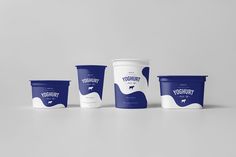 three yogurt cups sitting next to each other on a gray surface with white and blue designs