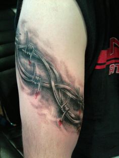 a man's arm with a tattoo on it that looks like an abstract design