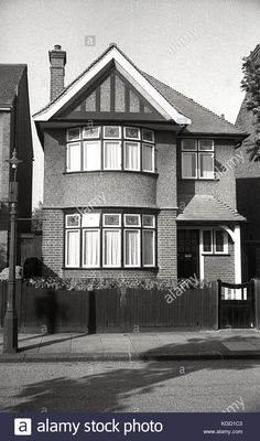 black and white photograph of a house in the suburbs