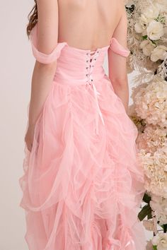 Step into a fairytale in the enchanting Aurora Dress. Crafted from the softest pink tulle, this gown feels like floating on a cloud. Cascading layers of draperies create a gorgeous, flowing silhouette that moves gracefully with every step. Lined with duchess satin, this piece is adorned with dreamy ribbon trims. Delicate off-shoulder sleeves and intricate corset lacing complete the romantic look. Handmade with love for the modern princess, the Aurora Dress is designed to be cherished and treasur Pink Fairytale Fairy Dress With Ruffles, Pink Tulle Corset Dress With Ruffles, Pink Tulle Fairycore Dress, Elegant Pink Tulle Fabric With Ruffles, Pink Tulle Balletcore Dress, Cascading Layers, Corset Lacing, Aurora Dress, Duchess Satin