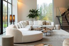 a living room filled with lots of white furniture