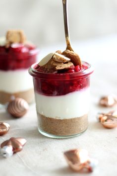 two desserts in small glass jars with spoons