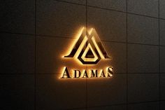 the logo for adams's is lit up against a dark wall with light shining on it