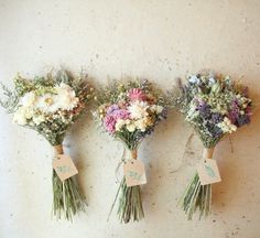 three bouquets of flowers with price tags on them