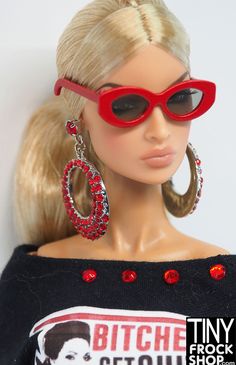 a barbie doll wearing red sunglasses and a black sweater