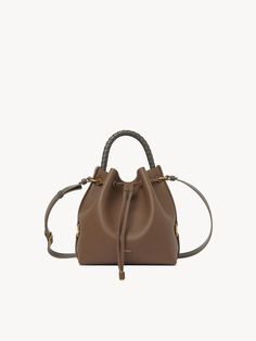 Chloé Marcie Bucket Bag | Chloé US Brown Leather Bucket Bag For Everyday Luxury, Leather Bucket Bag For Everyday Luxury, Pebbled Leather Bucket Bag With Detachable Strap, Pebbled Leather Bucket Bag With Textured Detail, Pebbled Leather Bucket Bag, Pebbled Leather Textured Bucket Bag, Pebbled Leather Bucket Bag With Removable Pouch, Textured Leather Bucket Bag For Travel, Leather Bucket Tote Bag