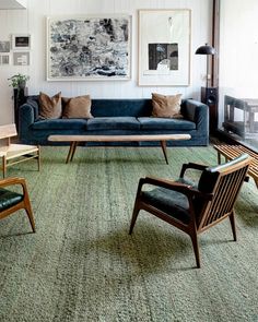 a living room filled with furniture and pictures on the wall