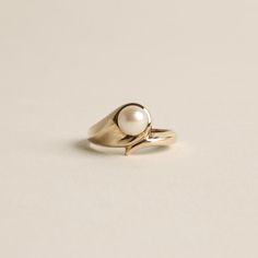 R I N G WITH WHITE PEARL ∙  ∙ SCROUPLES * Details: Solid Gold ∙ 8K Gold ∙ Yellow Gold * Stones: white pearl * Brand: Scrouples * Weight: 2.2 grams * Ring size: 5¼ * Condition: All our pieces are vintage, antique or close to new. The piece undergoes a restoration proces, which includes ultrasonic cleaning and mild polish techniques to enhance the condition of the piece. * All our pieces are vintage and handpicked. We put a lot of effort into finding the most unique and beautiful items for you guy Classic Everyday Pearl Drop Ring, Everyday Classic Pearl Drop Ring, Classic Everyday Pearl Ring, Timeless White Pearl Ring In 14k Gold, Classic Everyday Yellow Gold Pearl Ring, Fine Jewelry White Pearl Birthstone Ring, White Pearl Birthstone Ring In Fine Jewelry, White Pearl Birthstone Ring Fine Jewelry, Classic Pearl Birthstone Ring For Anniversary