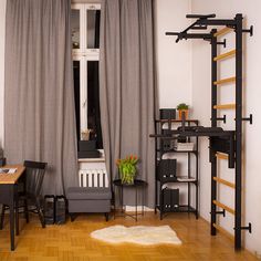 a room with a desk, chair and book shelf in it that has a ladder on the wall