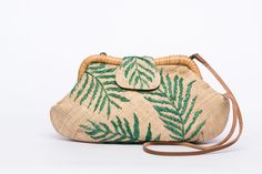 Palm Leaves Signature Larone Purse, handwoven from raffia with embroidered daisies and a rattan frame, featuring a leather strap for a sustainable, chic accessory. Embroidered Natural Straw Travel Bag, Natural Embroidered Straw Bag For Daily Use, Embroidered Natural Shoulder Bag For Travel, Traditional Embroidered Natural Color Bag, Traditional Handwoven Clutch Bag, Eco-friendly Handwoven Clutch For Daily Use, Handwoven Natural Clutch Shoulder Bag, Handwoven Natural Color Clutch Shoulder Bag, Natural Handwoven Clutch Shoulder Bag