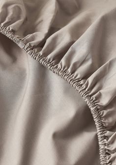 the zippers and ruffled edges of an unmade comforter are visible in this close up photo