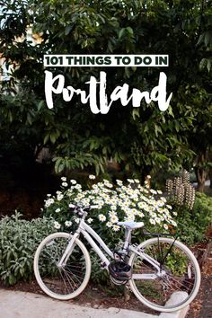 a bike parked next to a bush with daisies in the foreground and text overlay that reads 101 things to do in portland