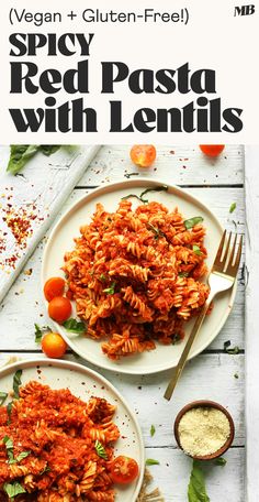 two plates filled with pasta and sauce on top of a white wooden table next to silverware