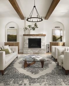 a living room filled with furniture and a fire place in the middle of a room