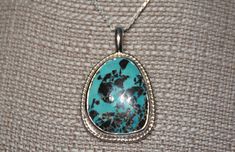 One of a kind, handcrafted, American turquoise and sterling silver pendant. Measures about 48mm X 31mm. Chain not included. Unique Untreated Turquoise Necklace Gift, Unique Untreated Turquoise Necklace As Gift, Unique Untreated Turquoise Necklace For Gift, Engraved Turquoise Pendant Necklace, Handmade Turquoise Sterling Silver Round Pendant Necklace, Handmade Sterling Silver Turquoise Round Pendant Necklace, Handmade Sterling Silver Turquoise Teardrop Pendant Necklace, Handmade Turquoise Teardrop Pendant In Sterling Silver, Handmade Turquoise Teardrop Pendant Necklace In Sterling Silver