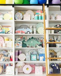 shelves filled with lots of different types of crafts and other items on top of them